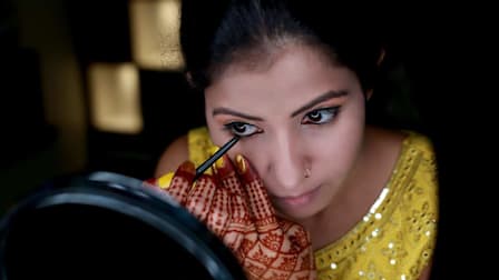 Woman applying kohl eyeliner.